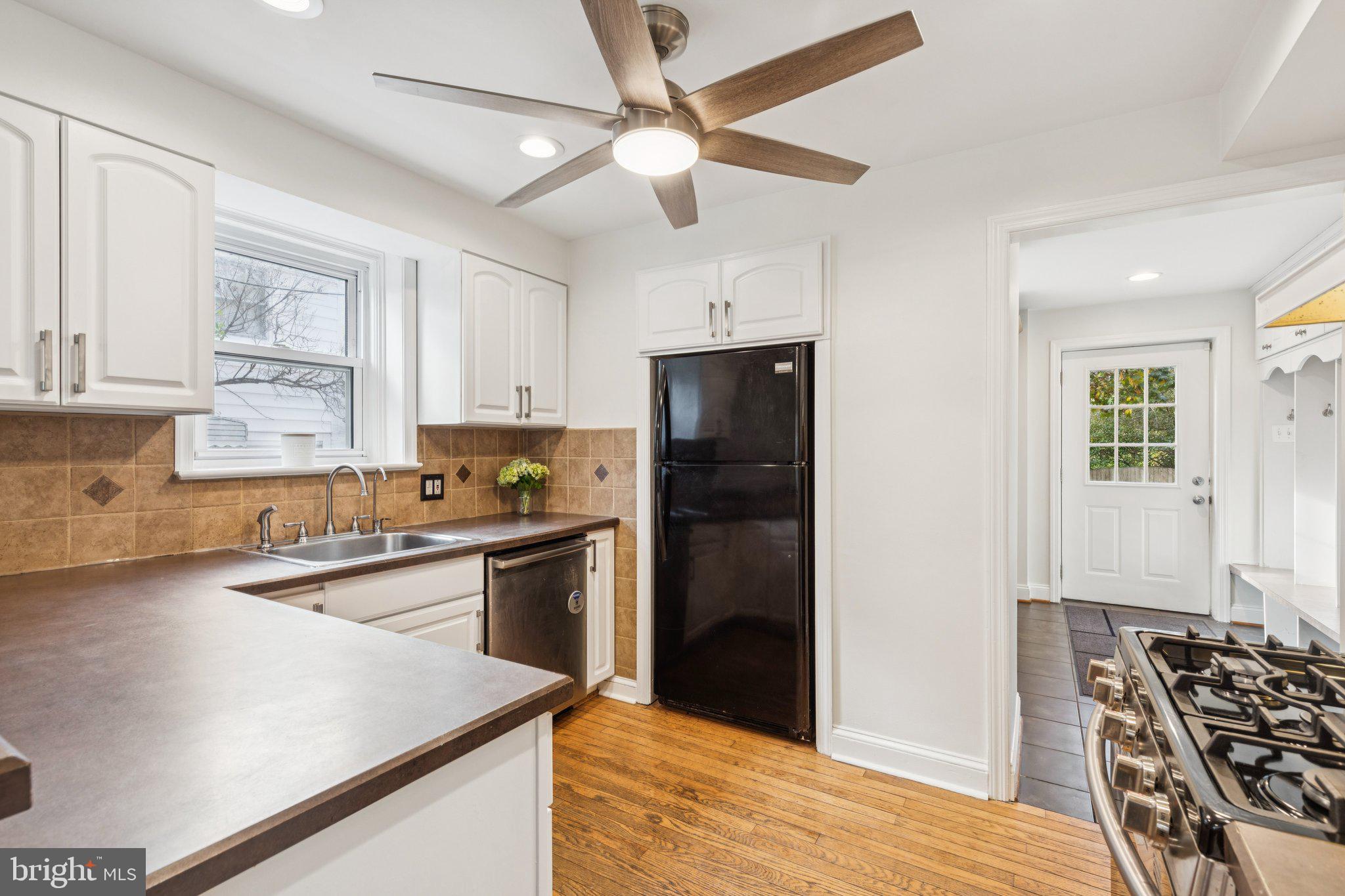 222 Harrogate Road Wynnewood, PA 19096 - Photo 14 of 43 a kitchen with stainless steel appliances granite countertop a sink stove and refrigerator