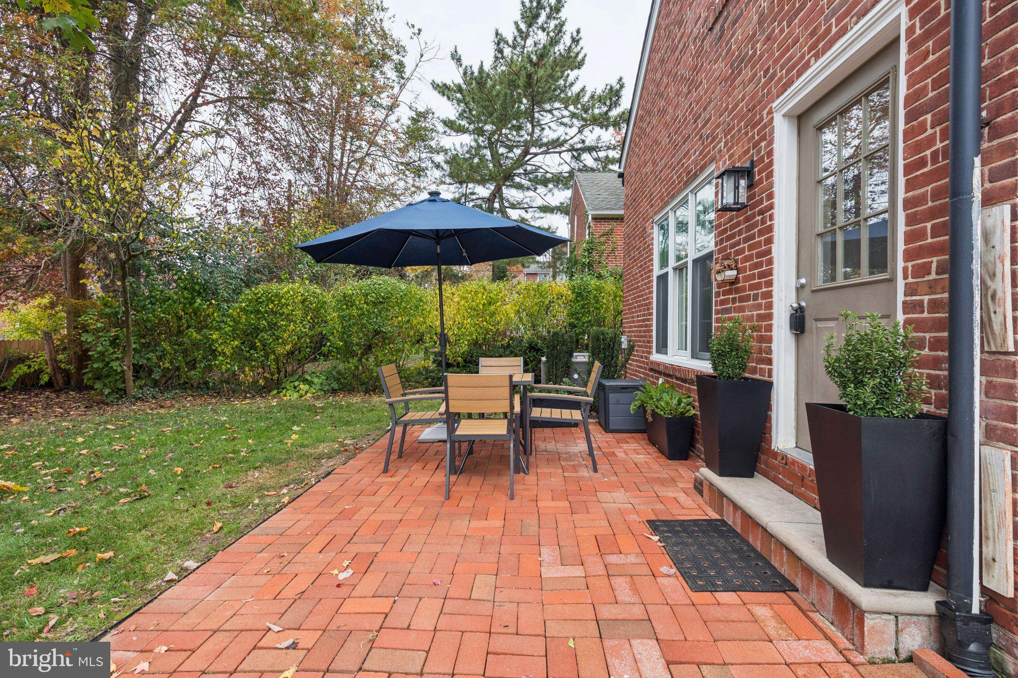 222 Harrogate Road Wynnewood, PA 19096 - Photo 21 of 43 a view of a patio with a table and chairs under an umbrella