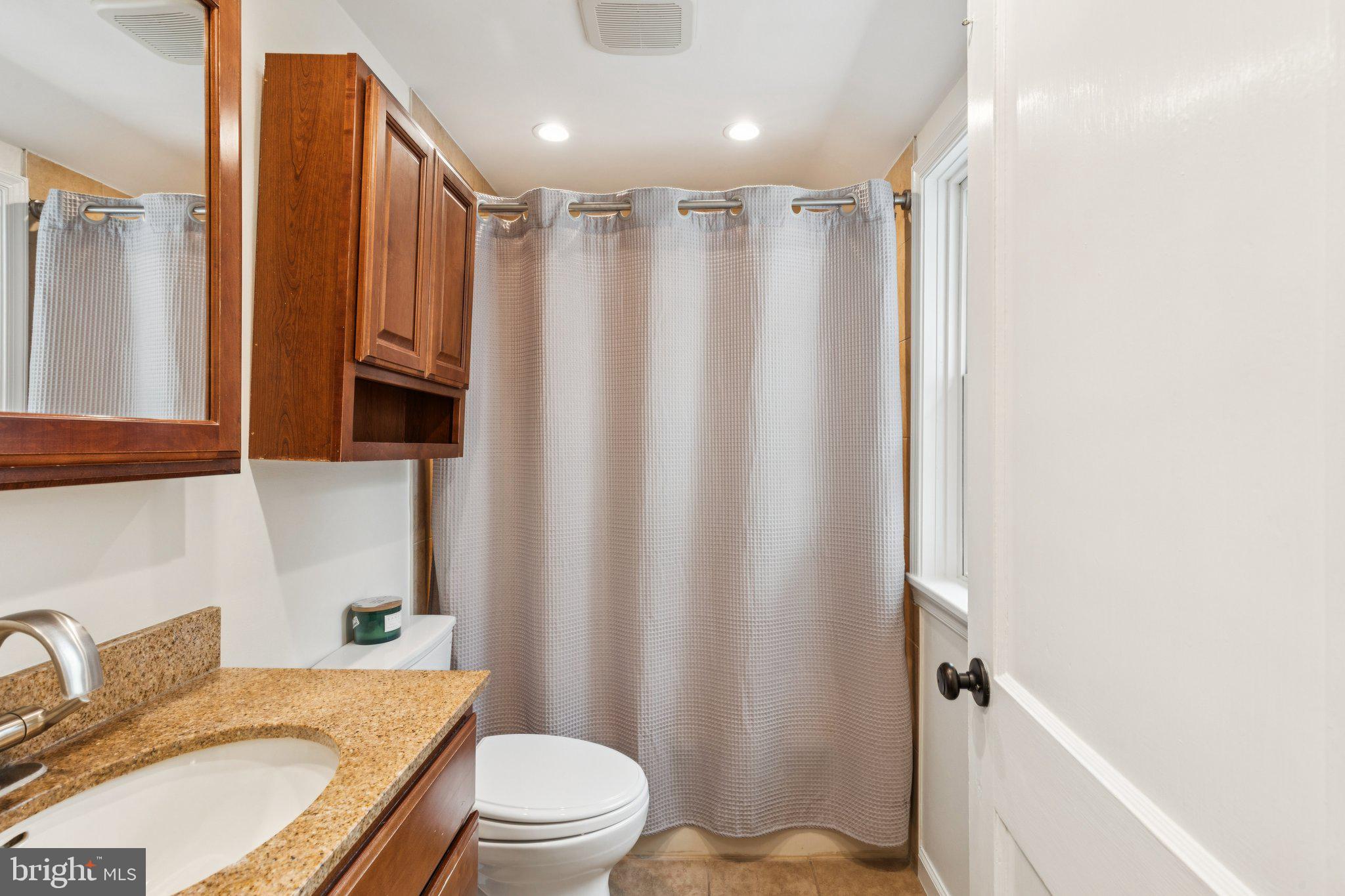 222 Harrogate Road Wynnewood, PA 19096 - Photo 25 of 43 a bathroom with a granite countertop bathtub shower sink vanity mirror and toilet