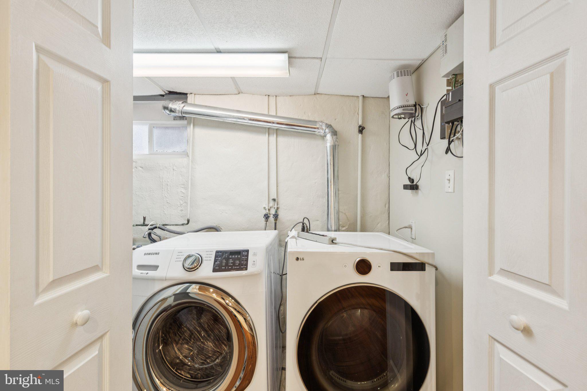 222 Harrogate Road Wynnewood, PA 19096 - Photo 38 of 43 a view of a storage & utility room with dryer and washer