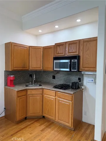a kitchen with stainless steel appliances granite countertop a sink stove and microwave