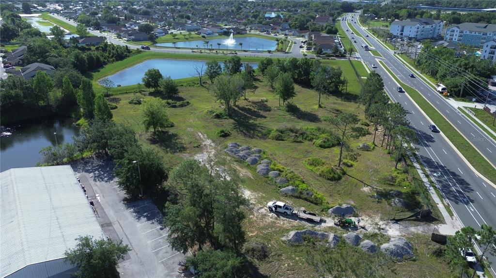 6347 Narcoossee Road Orlando, FL 32822 - Photo 15 of 17 an aerial view of residential houses with outdoor space and trees