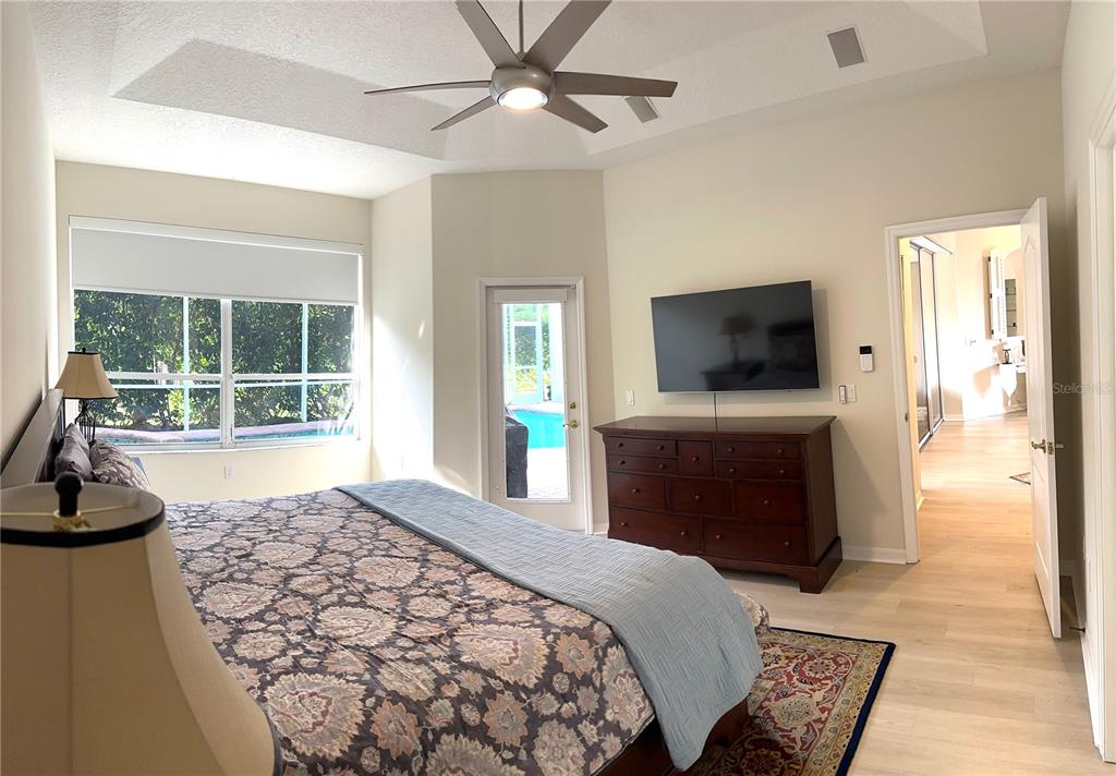 8870 Huntington Pointe Drive Sarasota, FL 34238 - Photo 13 of 28 a bedroom with a bed and a flat screen tv