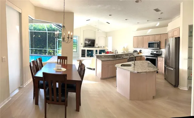 a kitchen with a table and chairs in it