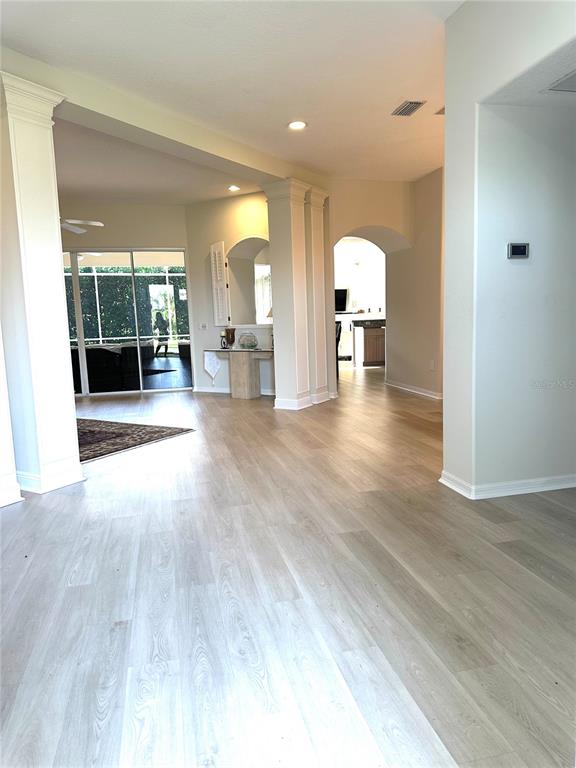 8870 Huntington Pointe Drive Sarasota, FL 34238 - Photo 3 of 28 a view of a livingroom with furniture wooden floor and window