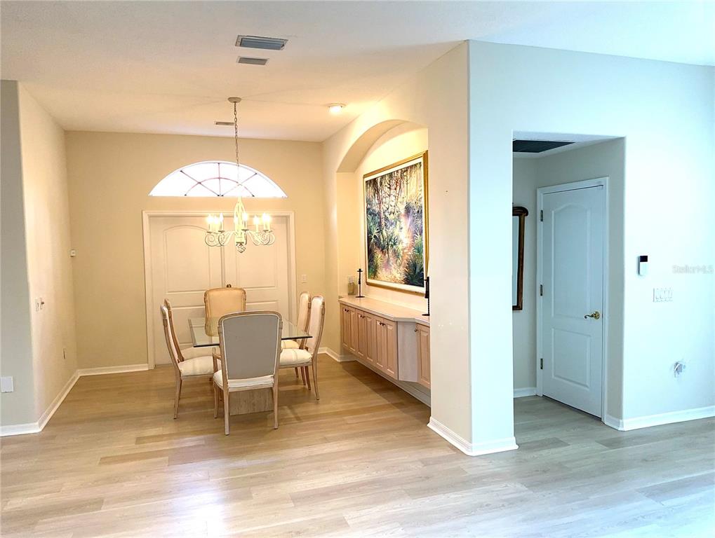 8870 Huntington Pointe Drive Sarasota, FL 34238 - Photo 5 of 28 a view of a dining room with furniture window and wooden floor