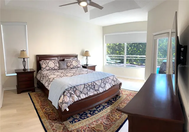 a bedroom with a bed and a large window