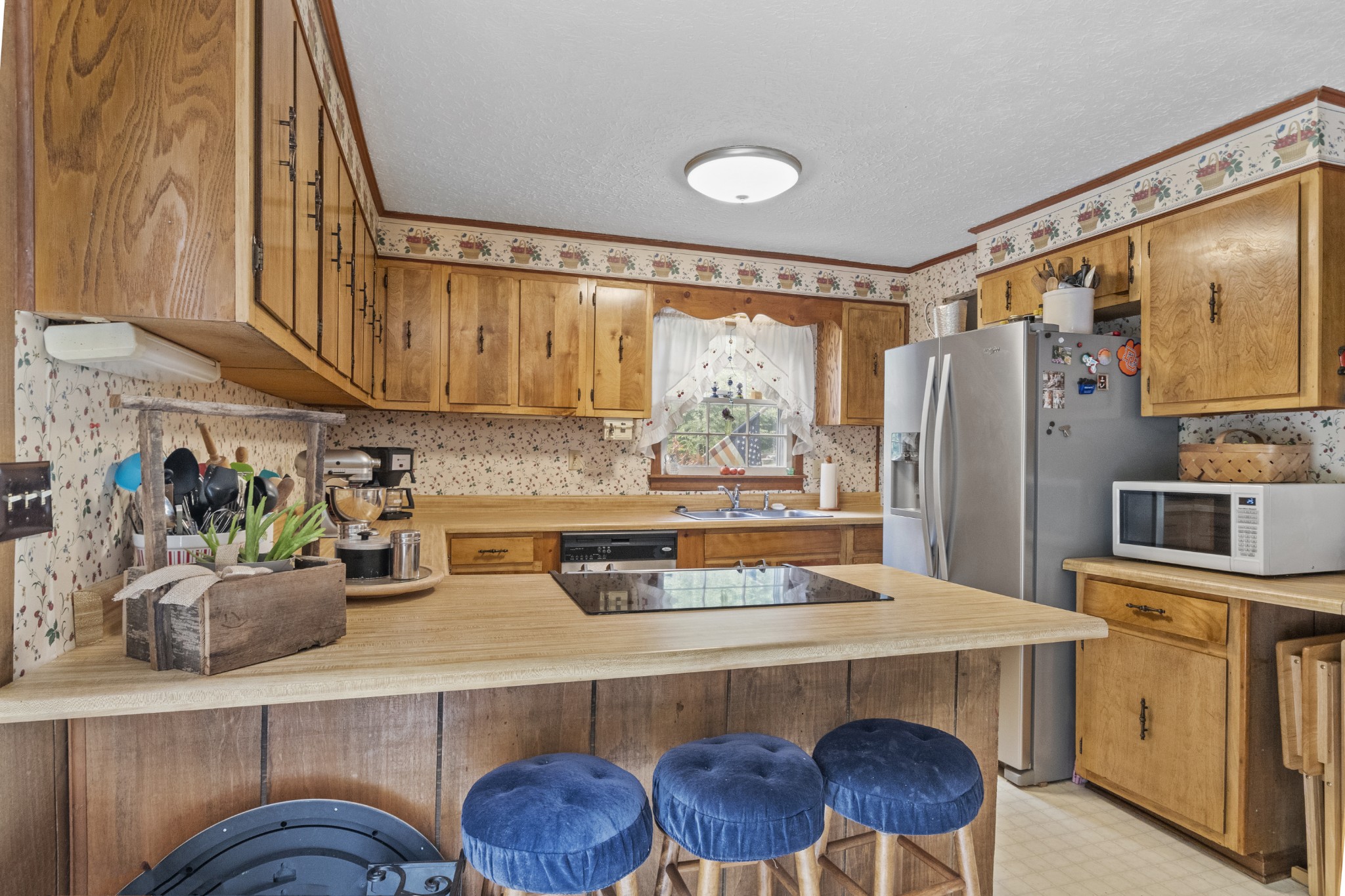 1095 Porter Road Burns, TN 37029 - Photo 2 of 34 a kitchen with a refrigerator and a stove