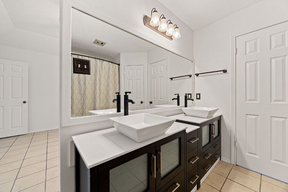 2602 Armstrong Drive Leander, TX 78641 - Photo 12 of 22 a kitchen with a sink and a refrigerator