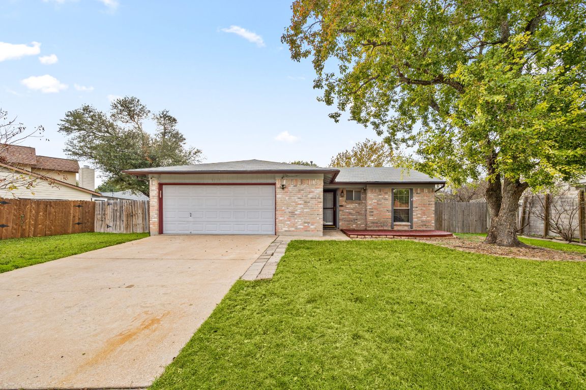 2602 Armstrong Drive Leander, TX 78641 - Photo 2 of 22 a front view of a house with a garden and trees