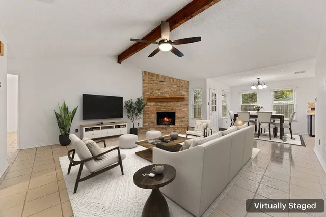 a living room with furniture a flat screen tv and a fireplace