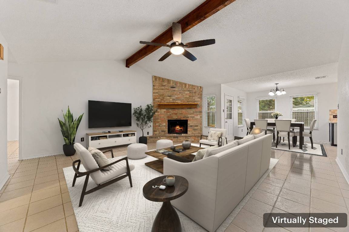 2602 Armstrong Drive Leander, TX 78641 - Photo 3 of 22 a living room with furniture a flat screen tv and a fireplace