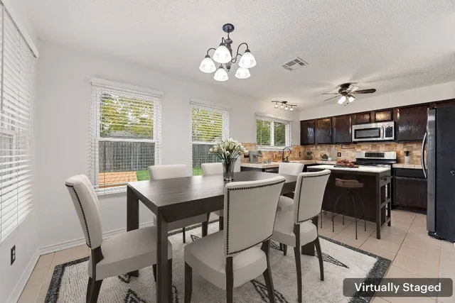 a view of a dining room with furniture and a chandelier