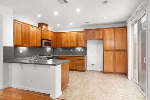 a kitchen with appliances cabinets and a sink