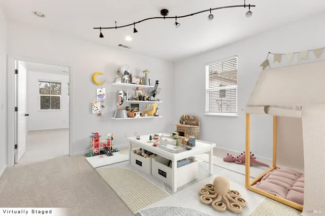 a bedroom with a large bed and a window