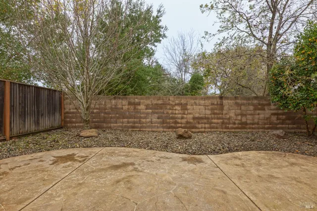 front view of a house with a large window and wooden fence