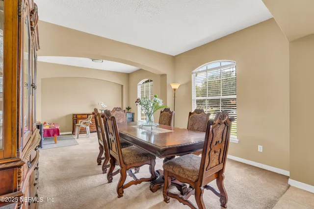 a view of a dining room with furniture and window