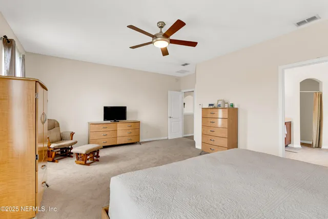 a bedroom with furniture and a large window