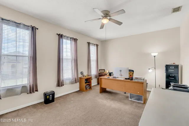 a bedroom with furniture and a large window