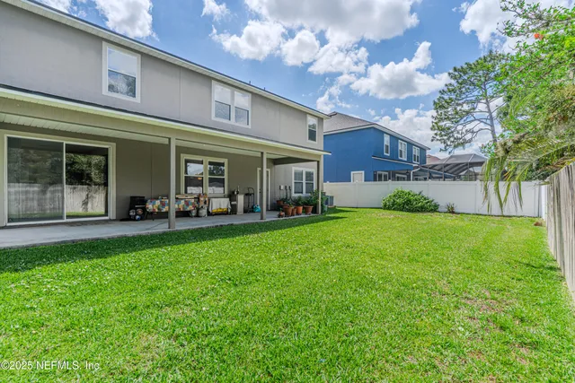 a view of a house with a backyard porch and sitting area
