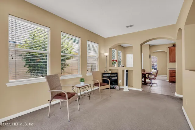 a view of a livingroom with furniture and a window