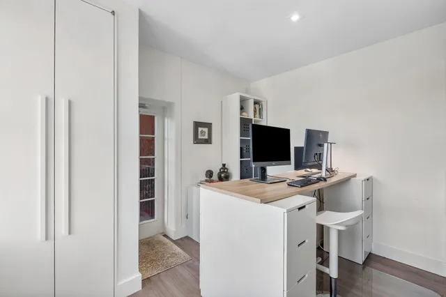a view of a livingroom with furniture and a flat screen tv