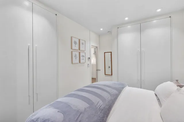 a bedroom with a bed and a shower