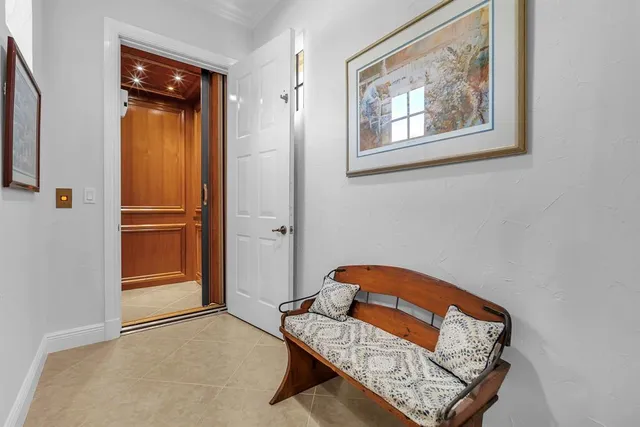 a living room with furniture a flat screen tv and a large window