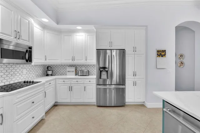 a kitchen with cabinets and stainless steel appliances