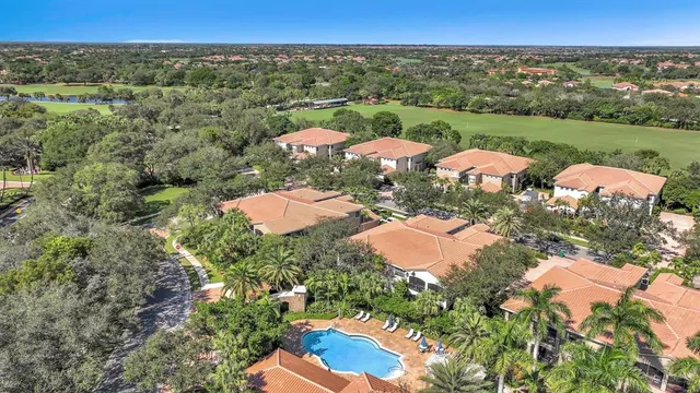 a dining room with stainless steel appliances kitchen island granite countertop a dining table chairs and a refrigerator