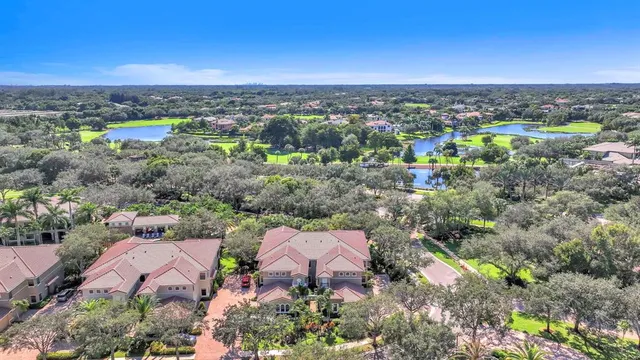 a living room with furniture a clock and a potted plant