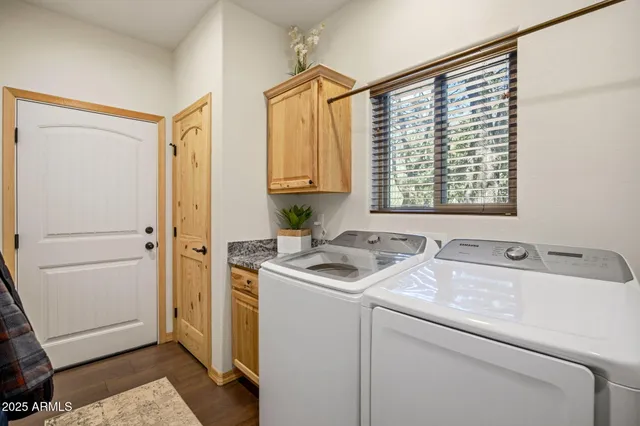 a bedroom with a bed a chair and painting on the wall