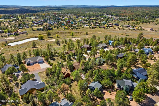 an aerial view of a house with a yard and garden