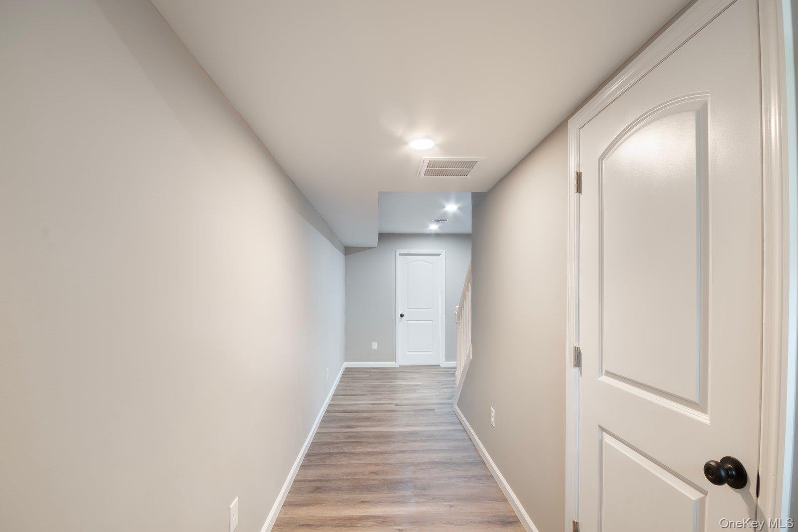 568 Granny Road Medford, NY 11763 - Photo 11 of 22 Hallway with baseboards and light wood-style flooring