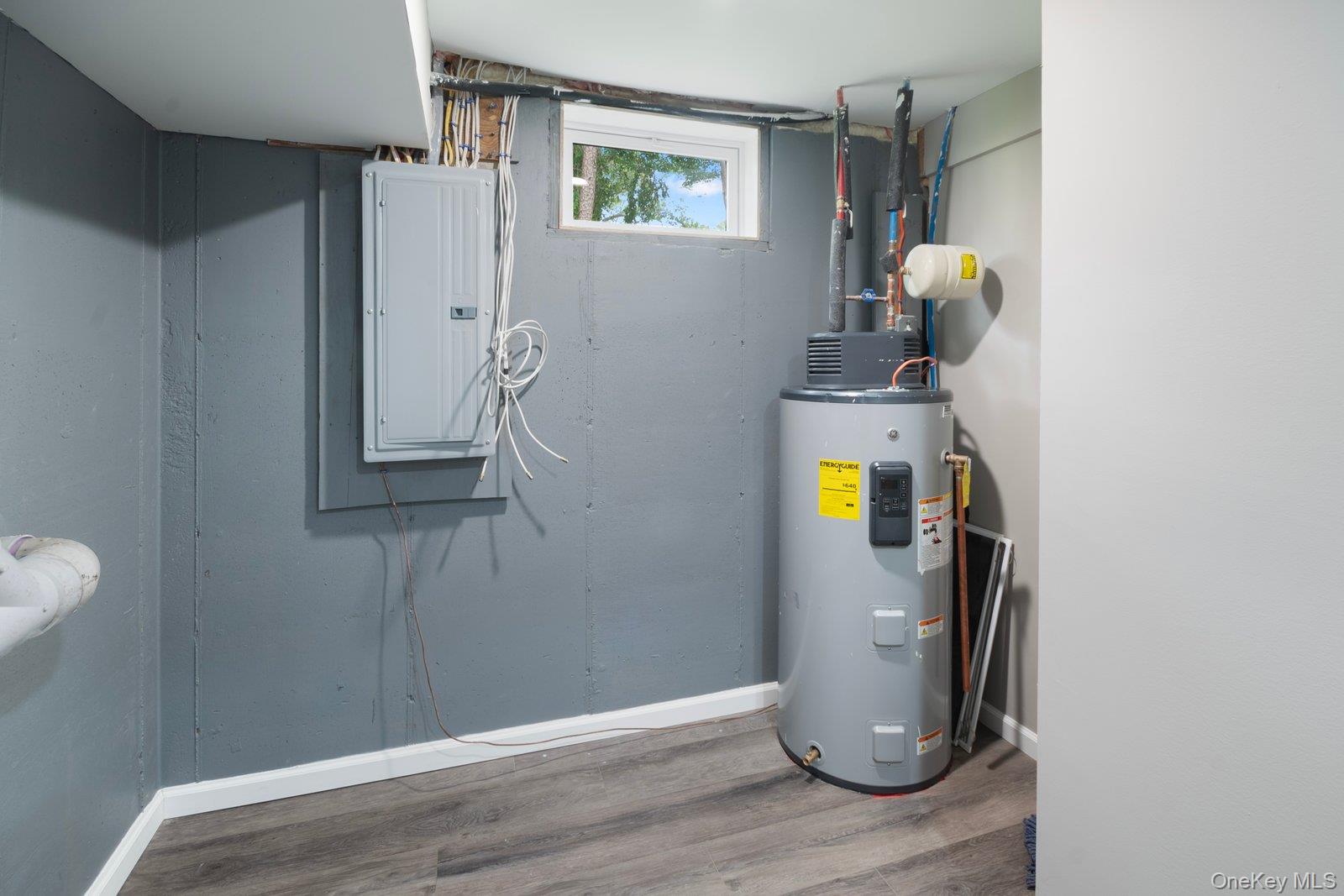 568 Granny Road Medford, NY 11763 - Photo 16 of 22 Utility room with electric panel and water heater