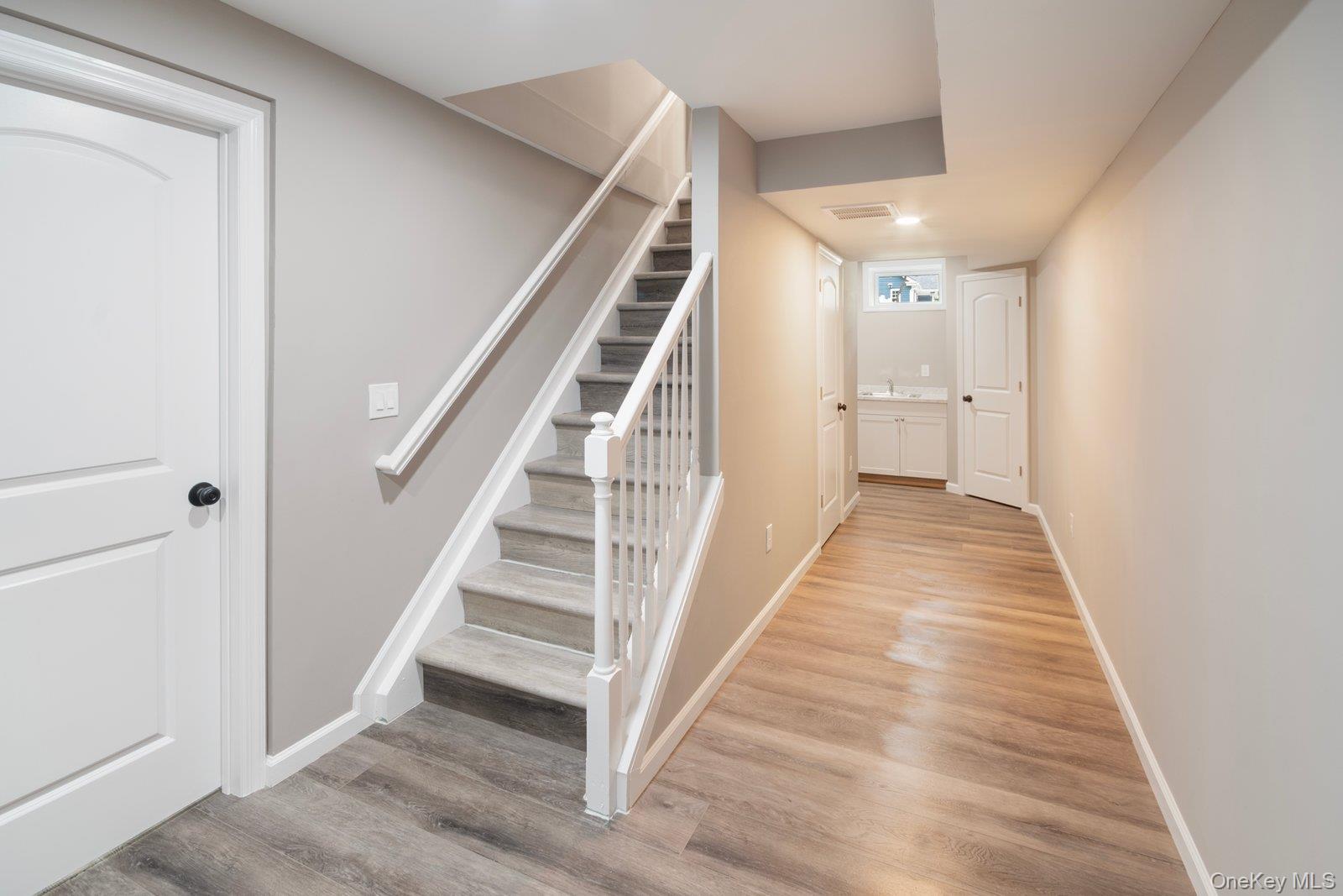 568 Granny Road Medford, NY 11763 - Photo 10 of 22 Stairs with wood finished floors