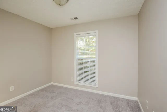 a view of an empty room with windows