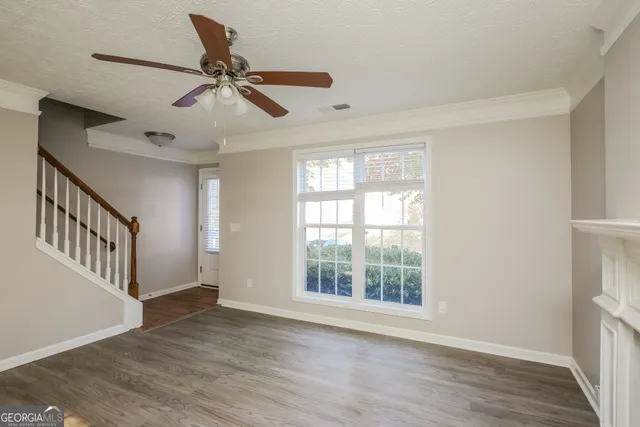 a view of an entryway with wooden floor