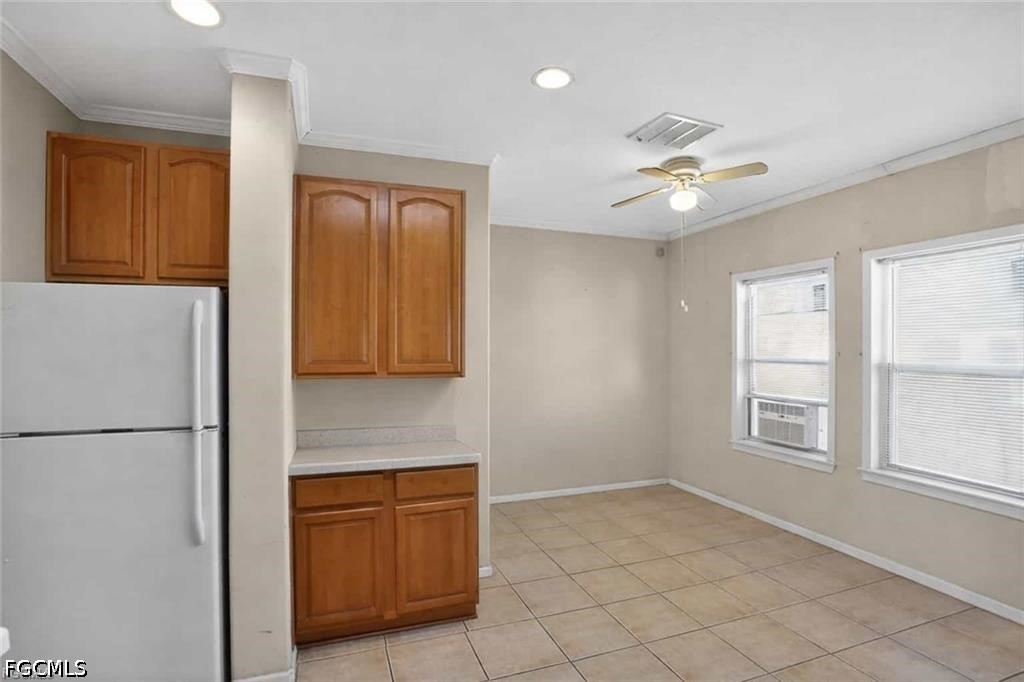2808 34th Street Southwest Lehigh Acres, FL 33976 - Photo 7 of 14 a kitchen with granite countertop a refrigerator a sink and dishwasher