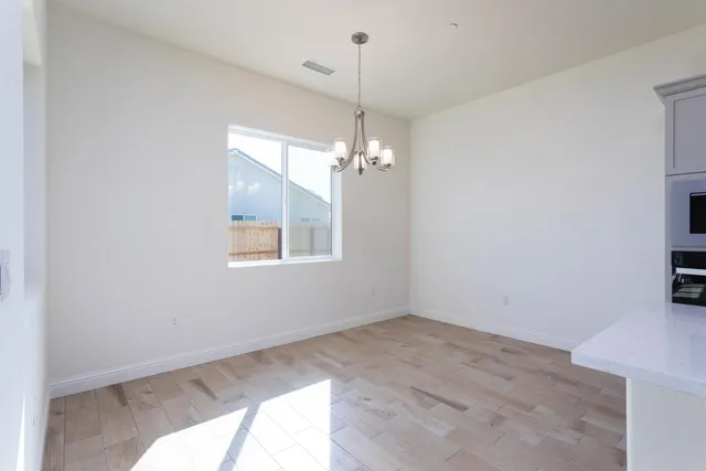 a view of a room with window and hardwood floor