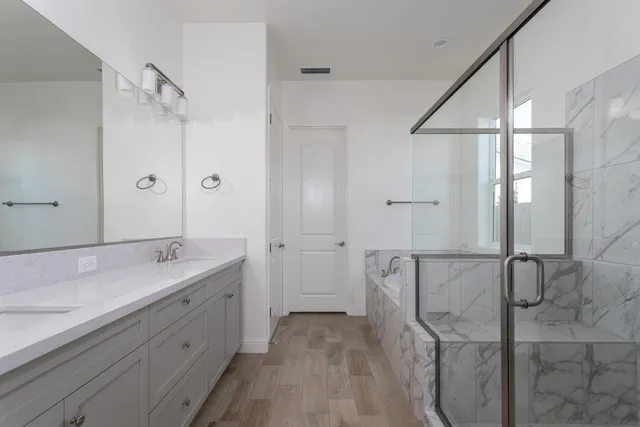 a spacious bathroom with a granite countertop sink mirror and double