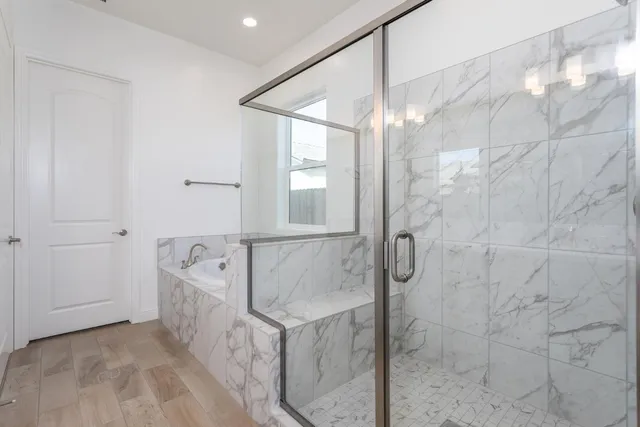 a bathroom with a bathtub and shower