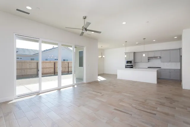 a view of large kitchen with a sink and wooden floor