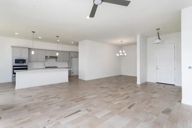 a view of kitchen with kitchen island and stainless steel appliances