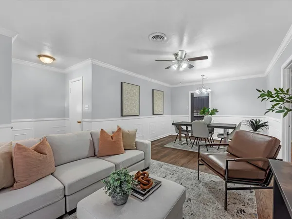 a living room with furniture and a chandelier
