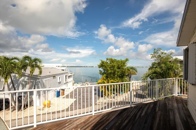 a view of a balcony with wooden floor