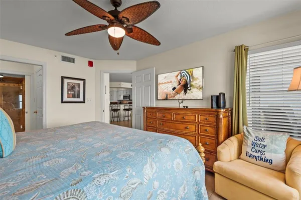 a bedroom with a bed and ceiling fan