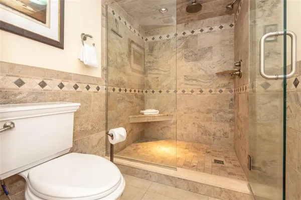 a white toilet sitting next to a bathroom sink