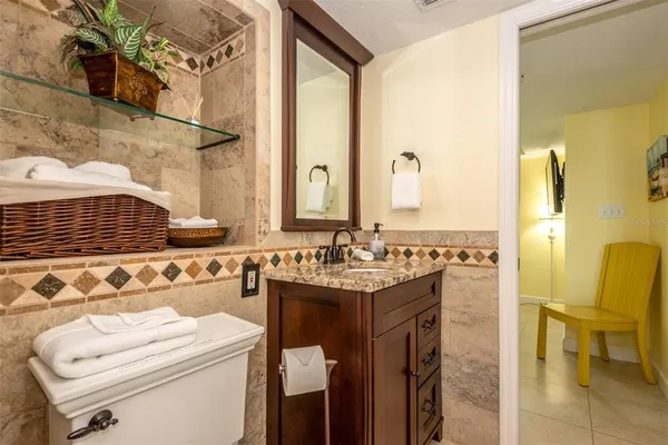 a bathroom with a sink a toilet and mirror