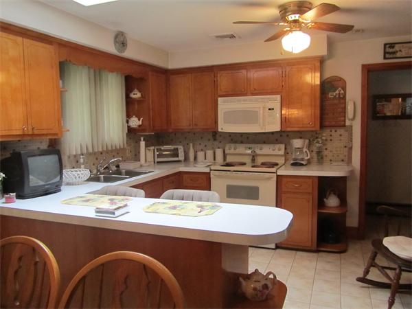 71 Isabel Street Fall River, MA 02721 - Photo 6 of 20 a kitchen with a sink a stove and chairs